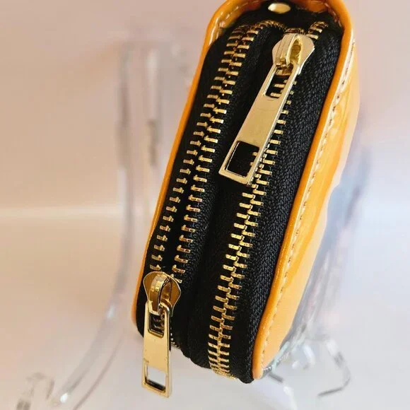 Glossy orange patent leather clutch wallet w/ images of famous women. - Picture 3 of 5